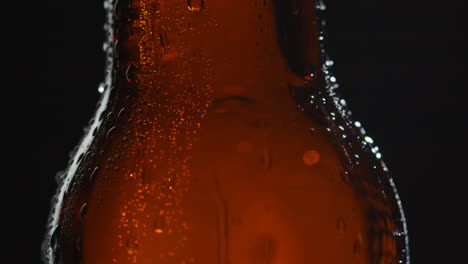 Close-Up-Of-Condensation-Droplets-Running-Down-Revolving-Bottle-Of-Cold-Beer-Or-Soft-Drink-1